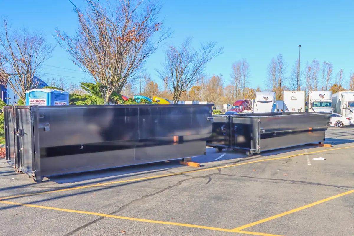 Professional dumpster rental service with roll-off container on residential driveway in Winter Haven